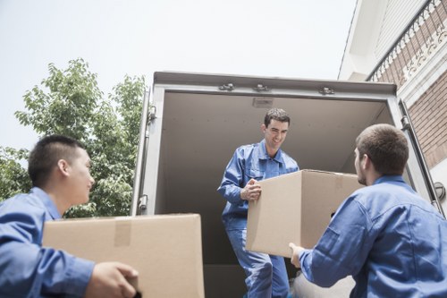 Moving team handling flat removals in Tooting near apartment stairs