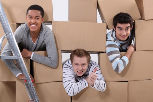 Removal professionals navigating a Tooting apartment access area