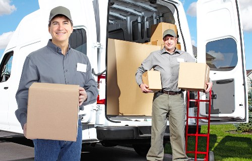Worker carrying out a risk assessment in a storage area